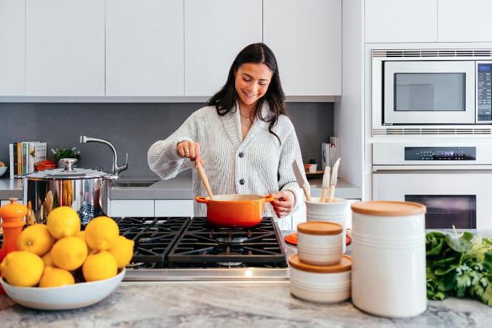 woman cooking inside kitchen room